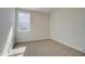 Serene carpeted bedroom bathed in natural light from the large window at 3941 Adler Cir, Buford, GA 30519