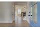 Inviting foyer featuring wood flooring, white trim, and a view of the living room and staircase at 3941 Adler Cir, Buford, GA 30519