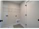 Functional laundry room featuring tile flooring, shelving, and washer/dryer hookups at 3941 Adler Cir, Buford, GA 30519