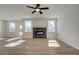 Inviting living room with plank flooring, a ceiling fan, and a modern fireplace with a dark surround at 3941 Adler Cir, Buford, GA 30519