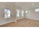 Bright and airy living room showcasing wood floors, large windows and white trim at 3941 Adler Cir, Buford, GA 30519