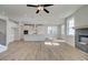 Open-concept living space featuring an island kitchen with sleek white cabinets and black-tiled fireplace at 3941 Adler Cir, Buford, GA 30519