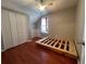 Bright bedroom featuring a window, closet, and hardwood floors at 3954 Lullwater Main Nw, Kennesaw, GA 30144