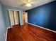 A minimalist bedroom with hardwood floors and ample closet space at 3954 Lullwater Main Nw, Kennesaw, GA 30144