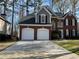 Charming two-story home featuring a brick facade and two-car garage at 3954 Lullwater Main Nw, Kennesaw, GA 30144