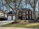 Charming two-story home featuring a brick facade and two-car garage at 3954 Lullwater Main Nw, Kennesaw, GA 30144