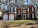 Charming two-story home featuring a brick facade and two-car garage at 3954 Lullwater Main Nw, Kennesaw, GA 30144