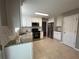 Updated kitchen featuring granite countertops, stainless steel appliances, and white cabinetry at 3954 Lullwater Main Nw, Kennesaw, GA 30144