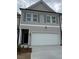 Two-story townhome features a gray exterior, shuttered windows, and a two-car garage at 1118 Edinburg Dr # 60, Villa Rica, GA 30180