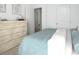 Bedroom showcasing light blue accents, minimalist decor, and bright lighting at 312 Naples Dr, Locust Grove, GA 30248