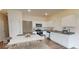 Kitchen and dining area with stainless steel appliances, white cabinets, and a marble-topped table at 312 Naples Dr, Locust Grove, GA 30248