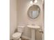 Powder room with pedestal sink, round mirror, and white toilet at 4524 Ajo Walk, Atlanta, GA 30331