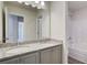 Bathroom vanity with double sink, grey cabinets, granite countertop and shower/tub combo at 4524 Ajo Walk, Atlanta, GA 30331