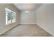 Bright dining room with wood-look flooring, large window, and modern chandelier at 4524 Ajo Walk, Atlanta, GA 30331