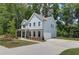 Side view of a blue two-story home with attached garage and concrete driveway at 4524 Ajo Walk, Atlanta, GA 30331