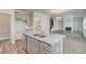 Kitchen island with granite countertop, stainless steel dishwasher and grey cabinets at 4524 Ajo Walk, Atlanta, GA 30331