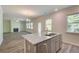 Kitchen island with granite countertop, stainless steel dishwasher and grey cabinets at 4524 Ajo Walk, Atlanta, GA 30331