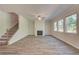 Bright living room with wood-look floors, fireplace, and multiple windows showcasing the outdoors at 4524 Ajo Walk, Atlanta, GA 30331