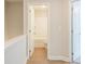 View to a bathroom showcasing a white toilet and tub/shower combo and view of hallway at 4671 Larkfield Way, Powder Springs, GA 30127