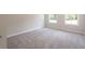 Bedroom with light grey carpet, light grey walls and natural lighting through large windows at 4671 Larkfield Way, Powder Springs, GA 30127