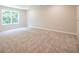 Carpeted bedroom featuring a large window at 4671 Larkfield Way, Powder Springs, GA 30127