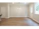 Well-lit dining area with luxury vinyl plank flooring and contemporary chandelier at 4671 Larkfield Way, Powder Springs, GA 30127