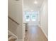 Hallway view into the open living area, featuring hardwood floors and natural light at 4671 Larkfield Way, Powder Springs, GA 30127