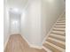 Entryway featuring hardwood floors and a staircase with natural wood treads and white risers at 4671 Larkfield Way, Powder Springs, GA 30127