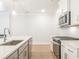 Modern kitchen featuring stainless steel appliances, white subway tile backsplash, and quartz countertops at 4671 Larkfield Way, Powder Springs, GA 30127