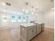 Open concept kitchen with white quartz countertops, stainless steel appliances, and pendant lighting at 4671 Larkfield Way, Powder Springs, GA 30127