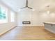 Bright living room featuring sleek hardwood floors, neutral paint, a ceiling fan, and an electric fireplace at 4671 Larkfield Way, Powder Springs, GA 30127