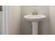 Classic pedestal sink in a well lit powder room at 4671 Larkfield Way, Powder Springs, GA 30127