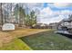 The backyard has a fenced in yard, and includes a shed and a small patio at 1531 Autumn Wood Trl, Buford, GA 30518
