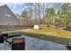 Backyard features a fenced yard, a small patio with furniture and a shed at 1531 Autumn Wood Trl, Buford, GA 30518