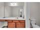Bathroom vanity with cherry cabinets and tile floors at 1531 Autumn Wood Trl, Buford, GA 30518