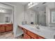 Spacious bathroom has double vanities with cherry cabinets and tile floors at 1531 Autumn Wood Trl, Buford, GA 30518