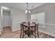 Cozy dining area with wood floors, chandelier, and natural light at 1531 Autumn Wood Trl, Buford, GA 30518