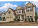 Attractive two-story home with a well-maintained lawn, appealing architectural details, and a convenient attached garage at 1531 Autumn Wood Trl, Buford, GA 30518
