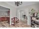 Welcoming foyer with wood floors, a decorative bench, and open views of the kitchen and office at 1531 Autumn Wood Trl, Buford, GA 30518
