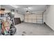 The garage is spacious with a door ready to open, along with room for storage at 1531 Autumn Wood Trl, Buford, GA 30518