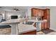 Eat-in kitchen featuring stainless steel appliances, wooden cabinets, and breakfast bar at 1531 Autumn Wood Trl, Buford, GA 30518