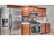 Well-equipped kitchen with stainless steel appliances, wood cabinets, and plenty of counter space, perfect for cooking at 1531 Autumn Wood Trl, Buford, GA 30518