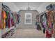 Large walk-in closet with hanging racks, shelving and chandelier at 1531 Autumn Wood Trl, Buford, GA 30518
