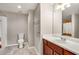 Neutral toned bathroom featuring a single vanity, mirror, and tiled shower with curtain at 2700 Pine Tree Ne Rd # 1117, Atlanta, GA 30324