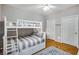 Cozy bedroom featuring a bunk bed with striped bedding and hardwood floors at 2700 Pine Tree Ne Rd # 1117, Atlanta, GA 30324