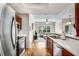 Bright kitchen featuring stainless steel appliances, wood cabinets, hardwood floors, and a view into the living room at 2700 Pine Tree Ne Rd # 1117, Atlanta, GA 30324