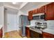 Kitchen with stainless steel appliances, wood cabinets, white counters, and light hardwood flooring at 2700 Pine Tree Ne Rd # 1117, Atlanta, GA 30324