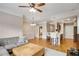 Open concept living room with a large sectional couch, center rug, hardwood floors, and kitchen access at 2700 Pine Tree Ne Rd # 1117, Atlanta, GA 30324