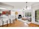 Open-concept living room featuring a breakfast bar, hardwood floors, and large windows at 2700 Pine Tree Ne Rd # 1117, Atlanta, GA 30324