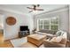 Cozy living room featuring a comfortable couch, large window, hardwood floors, and neutral decor at 2700 Pine Tree Ne Rd # 1117, Atlanta, GA 30324
